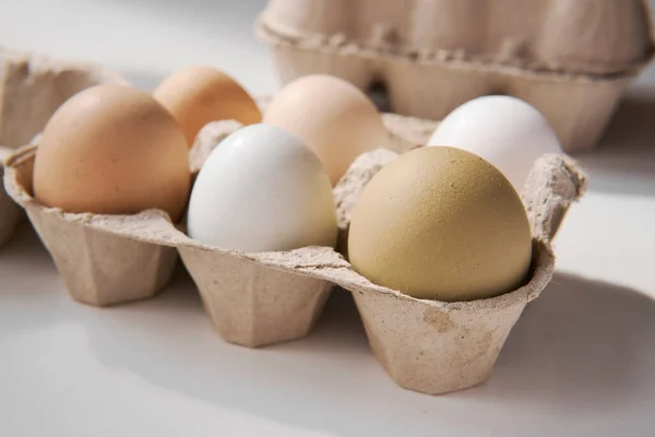 free range chicken eggs in a carton box with a \'happy eggs\' hand writing.