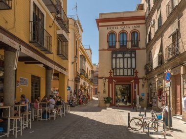 SEVILLE, SPAIN-MAY, 17, 2022: small narrow street in the historic old town of Seville, Spain