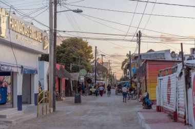 HOLBOX, MEXICO-MARCH 25, 2018: Tourists on a sandy road in Holbox Island, Quintana Roo, Mexico