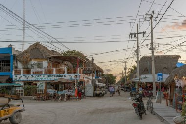 HOLBOX, MEXICO-MARCH 25, 2018: Tourists on a sandy road in Holbox Island, Quintana Roo, Mexico