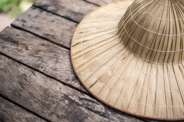 Close up Bamboo hat vintage on woowd table.
