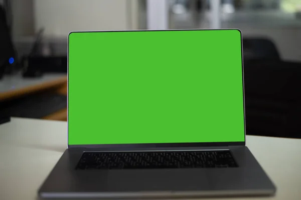 Laptop with green screen in office tecnology concept.
