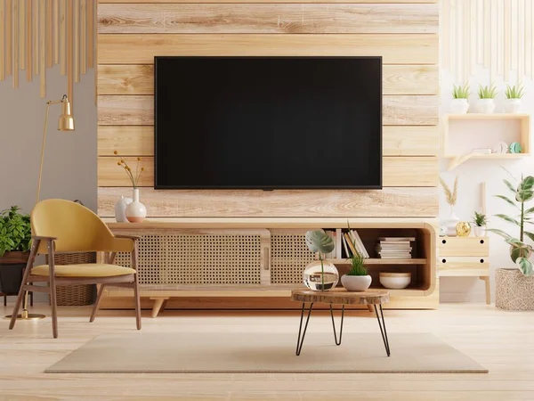 TV LED on the cabinet in modern living room with armchair on wooden wall background.3D rendering
