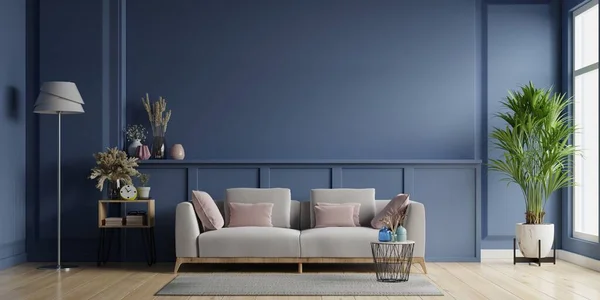 Modern minimalist interior design with gray sofa on empty blue wall background.3D rendering