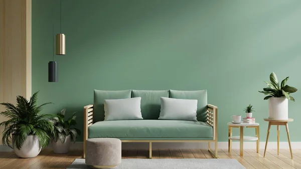 Mock up green wall with green sofa and decor in living room.3d rendering