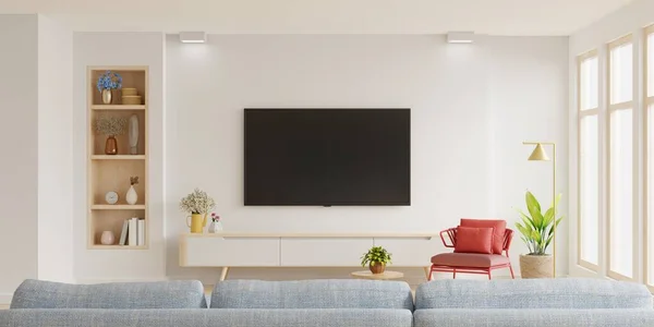 White wall mounted tv on cabinet in living room with red armchair and sofa,minimal design.3d rendering