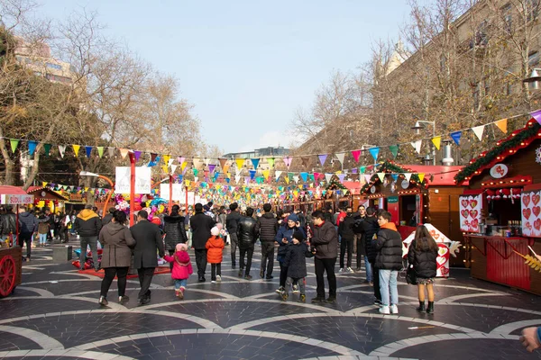 stock image Happy people celebrating the holiday. Christmas day in the central street of Baku - Azerbaijan: 31 December 2021