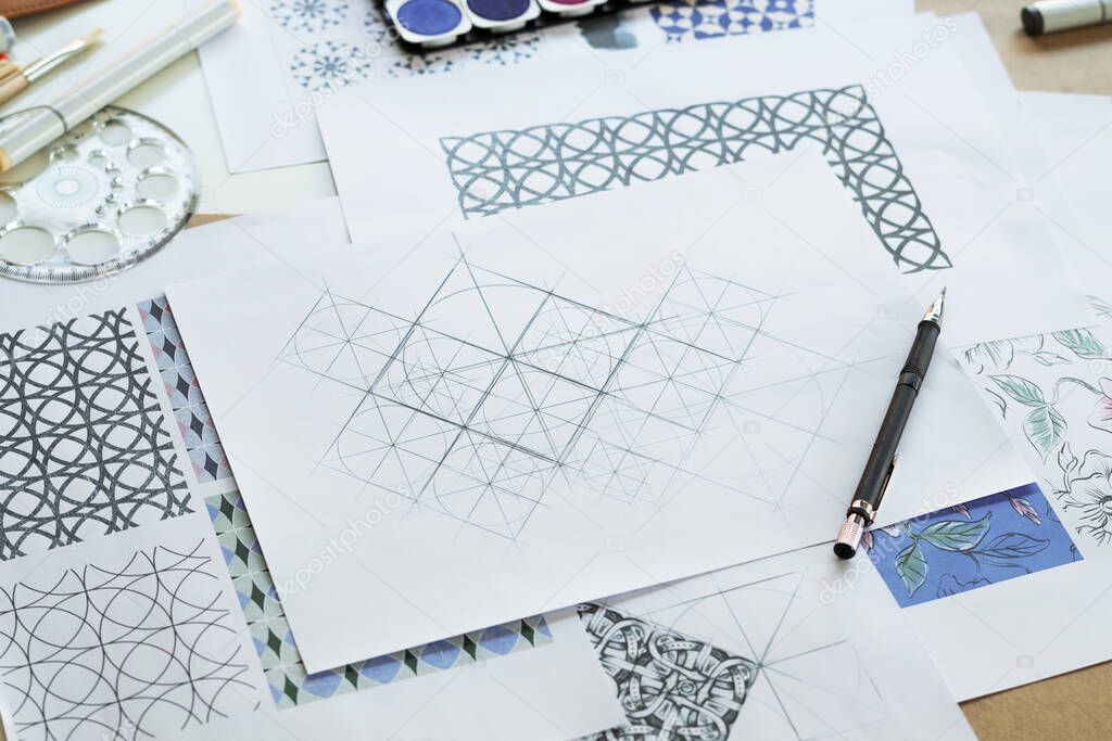 Designer designing drawing sketch pattern geometric flower seamless wallpaper fabric textile fashion industry. artistic design studio