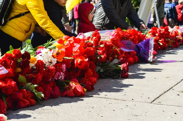 POLTAVA, UKRAINE  MAY 9, 2021: Laying red flowers to the monument on the holiday