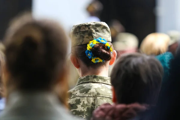 POLTAVA, UKRAINE  18 MAY, 2022: Ukrainian military with jewelry on her hair in yellow and blue colors