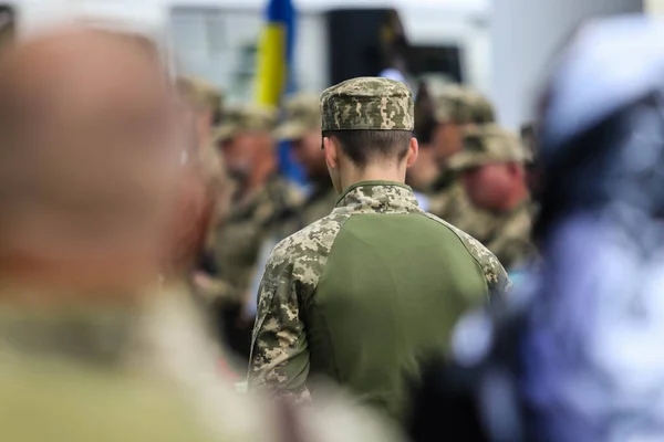 POLTAVA, UKRAINE  18 MAY, 2022: Ukrainian military in uniform among the people during the day