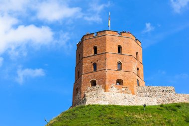 VILNIUS, LITHUANIA - 20 AĞUSTOS 2019: Gediminas 'ın kulesi, yaz öğleden sonra mavi gökyüzünün arka planında yeşil bir tepe üzerinde