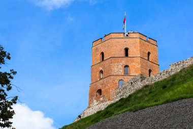 VILNIUS, LITHUANIA - 20 AĞUSTOS 2019: Gediminas 'ın kulesi, yaz öğleden sonra mavi gökyüzünün arka planında yeşil bir tepe üzerinde