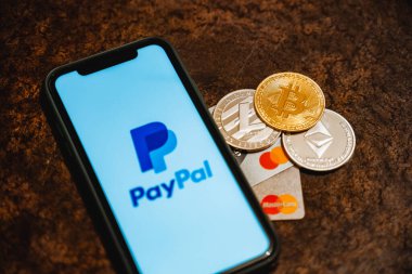 Ufa, Russia - January 12, 2022: Paypal payment system accepts bitcoin and other cryptocurrencies. Bitcoin along with bank cards. High quality photo