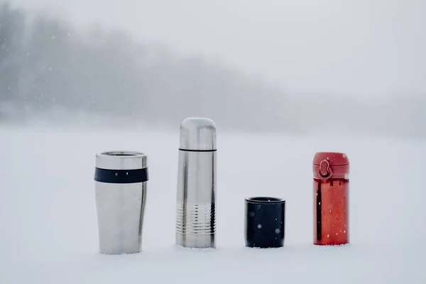 A set of thermoses of different sizes and shapes. Dishes for hot drinks. Tourist tableware made of metal. High quality photo
