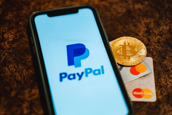 Ufa, Russia - January 12, 2022: Paypal and Bitcoin payment system. Mastercard together with cryptocurrency. High quality photo