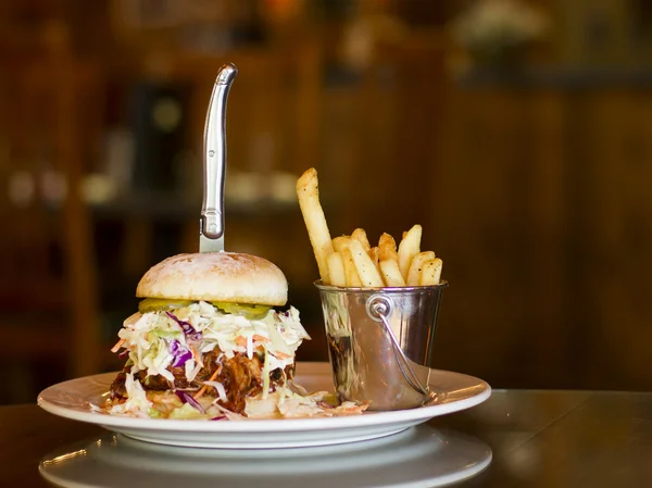 Pulled pork and coleslaw sandwich with garlic fries Stock Photo