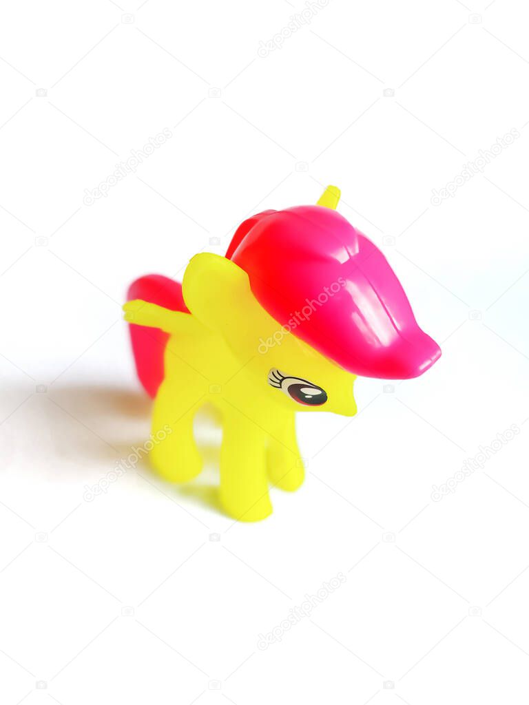 yellow toy horse on white background.