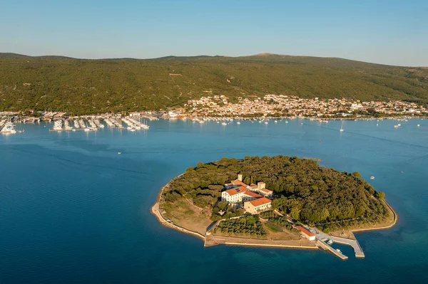 Aerial view of Kosljun monastery with Punat town in the background, Krk island, Croatia