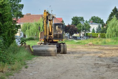 Bir yaz günü ağaçların arasında duran bir yol makinesi.. 