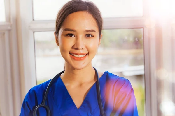 Profile portrait professional Asian female surgeon wearing blue uniform with gentle stethoscope positive attitude professional female doctor therapist.