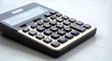 old black digital calculator on blurred background
