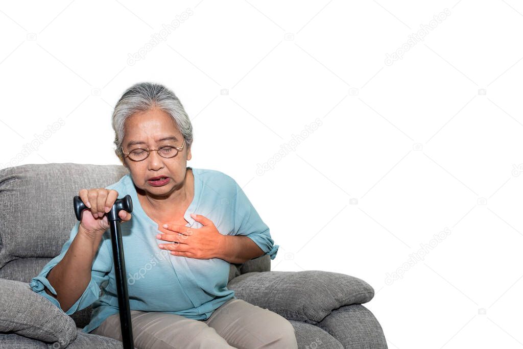 Asian elderly woman, sitting on a sofa and holding walkers in home, are suffering from angina Due to heart disease,  On white isolated background, to people retirement and health care concept.