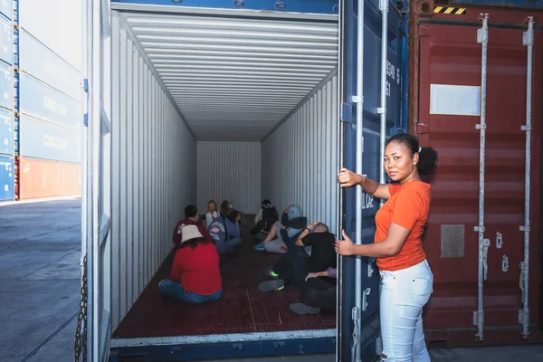 African Women Opening Door Container Which Several People Were Sitting — стоковое фото