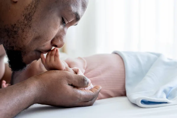 African American Father Kissing Hand His Baby Newborn Son Lying Stock Picture