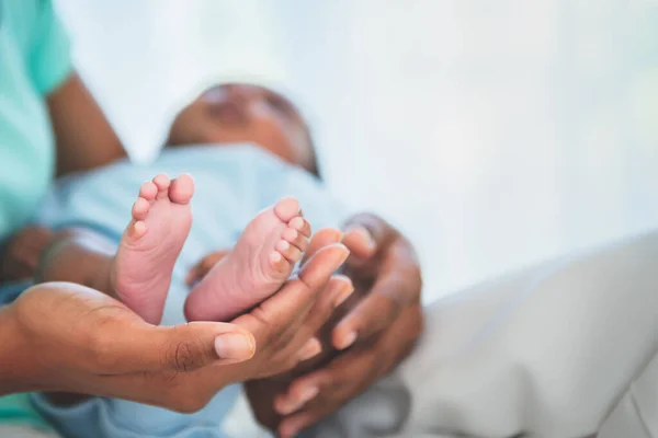 Blurred soft images, Baby\'s foot of African black skin newborn, Placed on the mother\'s hand, concept to showing love and concern for her children, And is love family relationship.