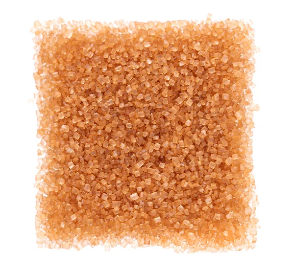 Açúcar mascavo isolado sobre fundo branco. Altura de cristais de cana-de-açúcar. Vista superior. — Fotografia de Stock