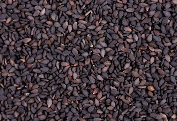 Black sesame seeds background. Organic spice. Top view. — Stockfoto