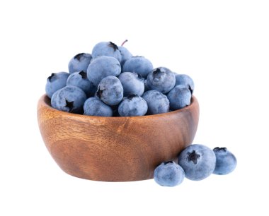 Fresh blueberry in wooden bowl, isolated on white background. Bilberry or whortleberry. Clipping path