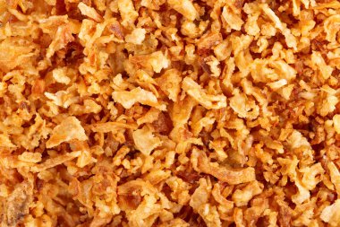 Roasted onions background. Crispy fried onions. Top view