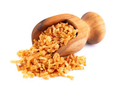 Roasted onions in wooden scoop, isolated on white background. Crispy fried onions