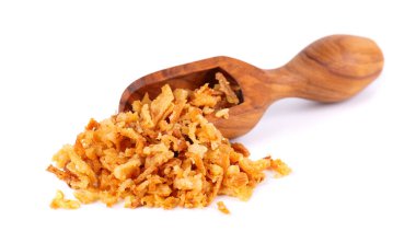 Roasted onions in wooden scoop, isolated on white background. Crispy fried onions