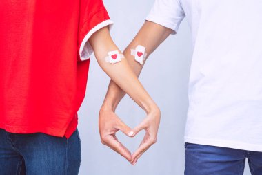 Blood donation. World blood donor day. Man and woman after giving blood. Save lives concept. clipart