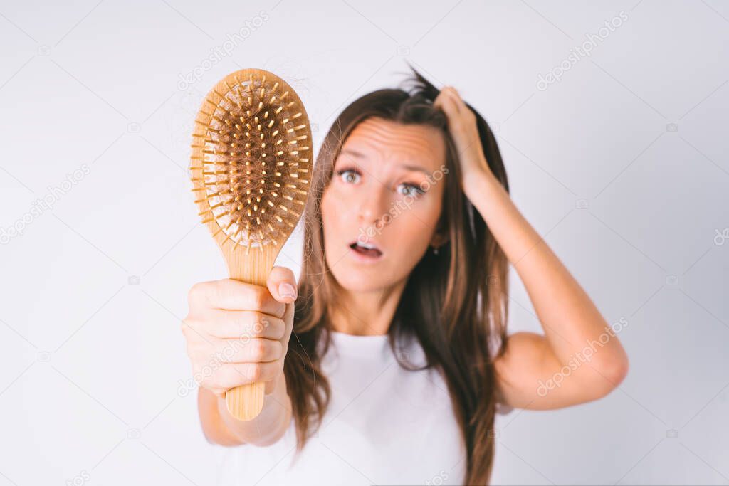 Shocked woman with hair loss problem. Hair falling out