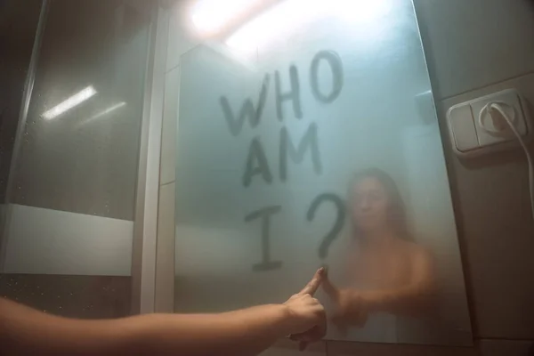 Woman writing on the mirror who am I. self awareness, identity or personality concept — Foto Stock