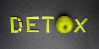 Clean healthy eating and detox diet concept. Word detox written on black background