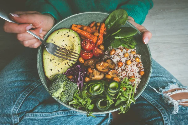 Woman holding plate with vegan or vegetarian food. Healthy diet. Healthy vegetable dinner or lunch. Tasty buddha bowl. Healthy vegan eating ストックフォト