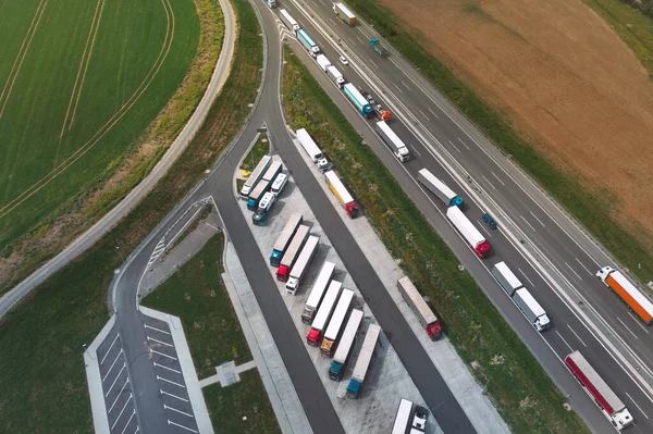 Aerial view of logistic traffic and parking lots full of trucks on highway in Poland. View from drone. High quality photo