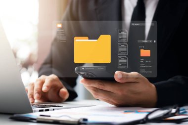 Document management system concept, business man holding folder and document icon software, searching and managing files online document database, for efficient archiving and company data.