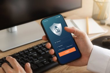 Cybersecurity internet and networking concept. hand holding smartphone information security and encryption, secure access to user's personal information, secure Internet access.	