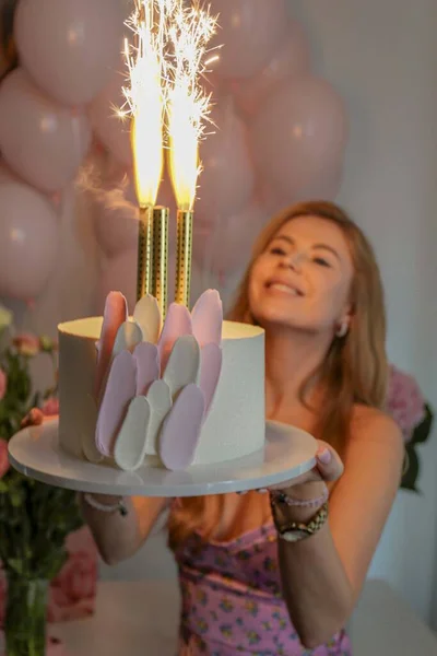 woman with a candle and cake on the party