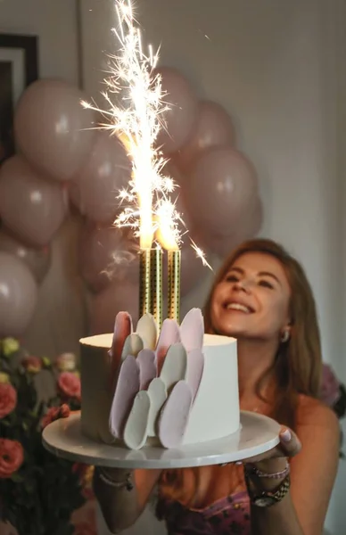 woman with a candle and cake on the party