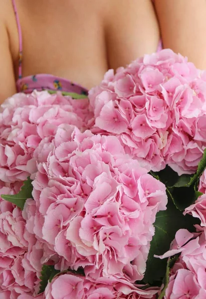 girl and pink flowers hydrangeas