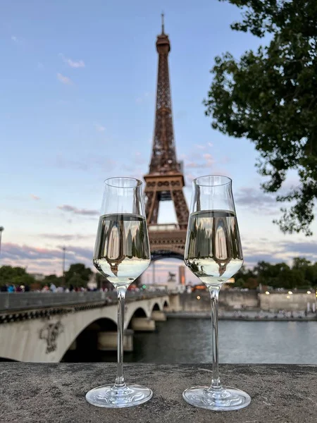 glasses of white wine in the background tower in Paris