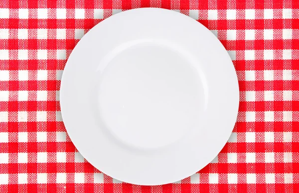 Plate on tablecloth — Stock Photo, Image
