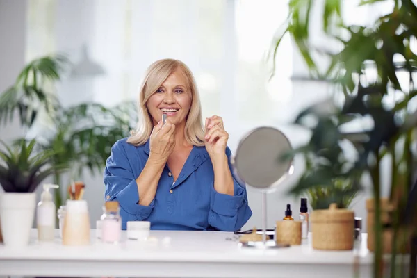 Eine Schöne Blonde Seniorin Sitzt Hause Und Setzt Sich Lippenstift — Stockfoto